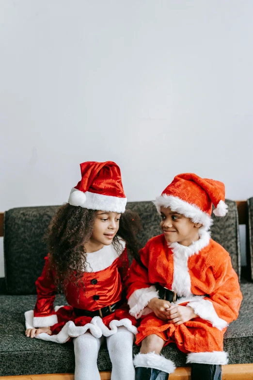 a couple of kids sitting on top of a couch, wearing a santa hat, diverse outfits, brown, profile pic