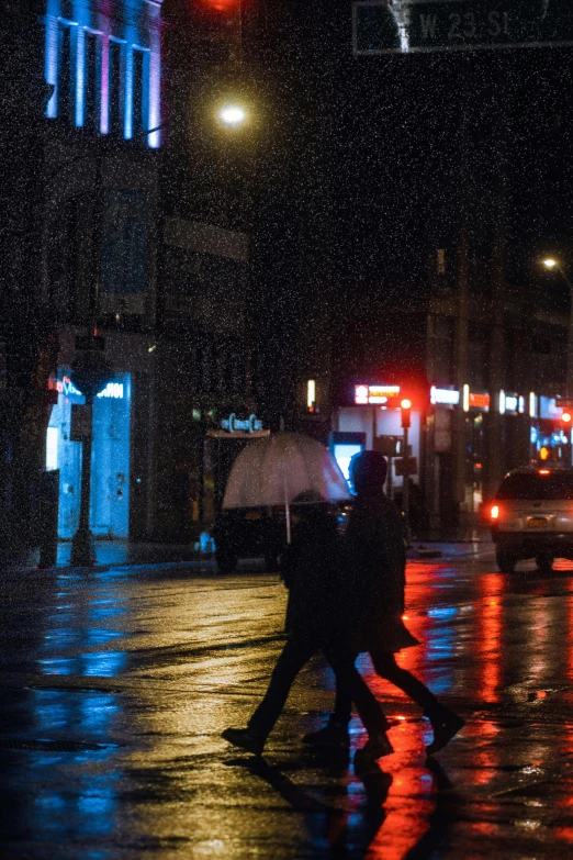 a couple of people crossing a street at night, inspired by Elsa Bleda, trending on unsplash, snowfall, montreal, umbrella, blue lights