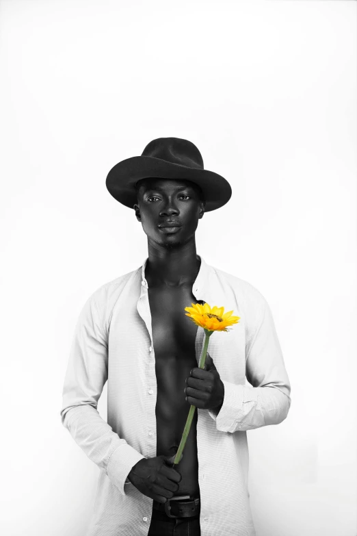 a man in a hat holding a yellow flower, a black and white photo, by Gavin Hamilton, pexels contest winner, minimalism, adut akech, model with attractive body, black skin!!!, 5 0 0 px models