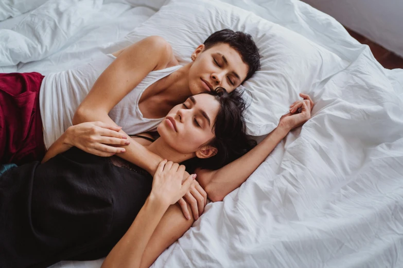 a couple of people laying on top of a bed, trending on pexels, lesbian, soft texture, holding an epée, realistic depth