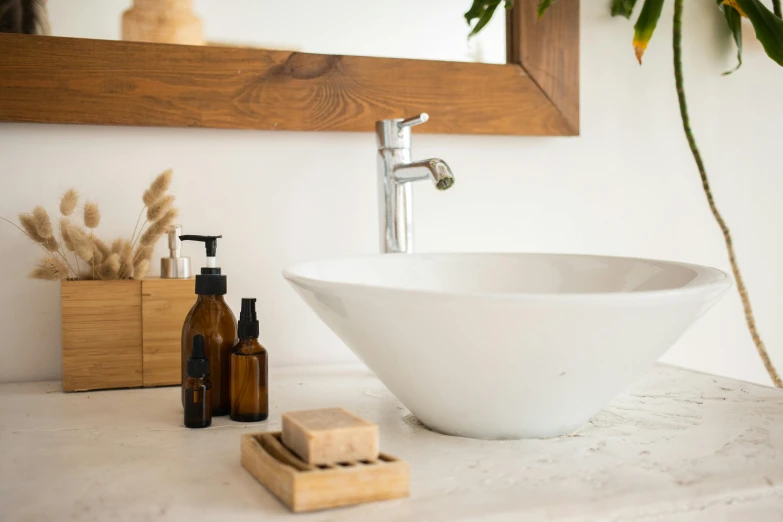 a white bowl sitting on top of a counter next to a mirror, pexels contest winner, sustainable materials, fountain of youth, marble and wood and glass, natural beard