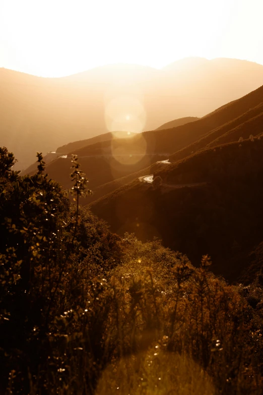 the sun is setting over the mountains in the distance, by Muggur, andes mountain forest, soft light - n 9, canyon, suns