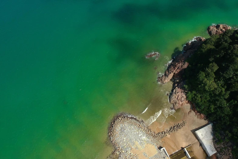 a large body of water next to a beach, pexels contest winner, top-down shot, a green, 8 k octane comprehensive render, wellington