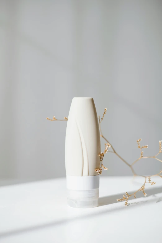 a white vase sitting on top of a white table, silicone skin, diffused natural skin glow, spire, features