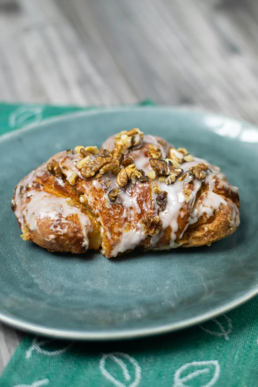 a close up of a plate of food on a table, in the shape of a cinnamon roll, irish, square, nut