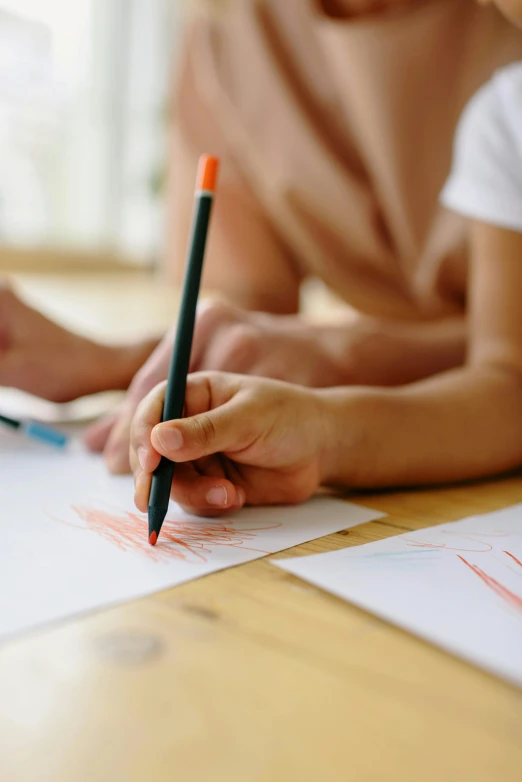 a couple of people that are sitting at a table, a child's drawing, pexels contest winner, holding pencil, crisp lines, split near the left, extreme foreshortening