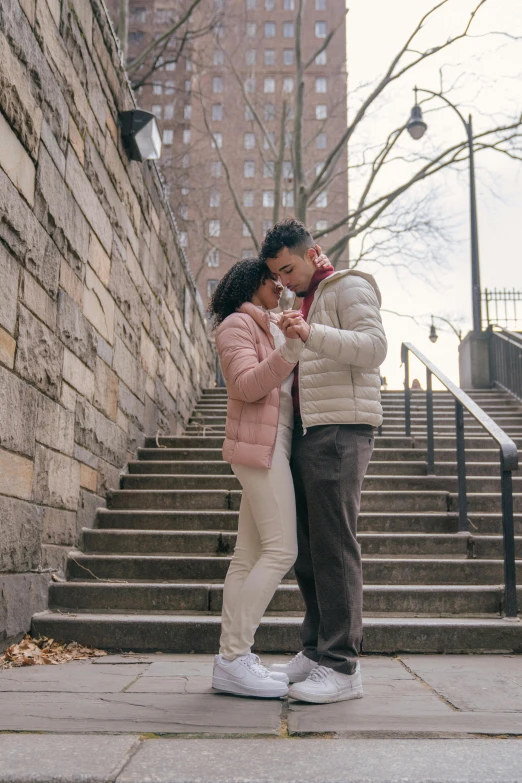 a man and a woman standing next to each other, inspired by Gina Pellón, pexels contest winner, happening, outdoor staircase, in new york, cute pose, ( ( theatrical ) )