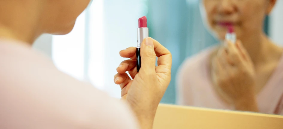 a woman brushing her teeth in front of a mirror, pexels contest winner, photorealism, lipstick, close-up shot taken from behind, colourised, holding pencil