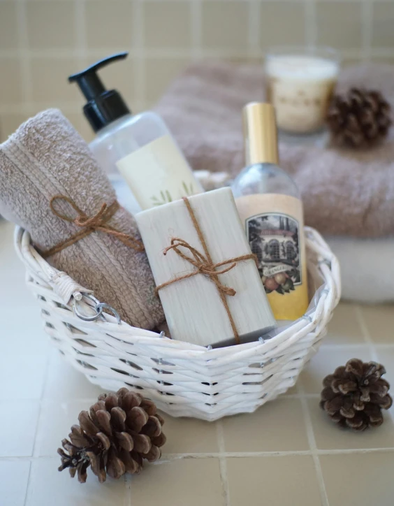 a basket filled with personal care items sitting on a counter, cosy, white ribbon, thumbnail, angled