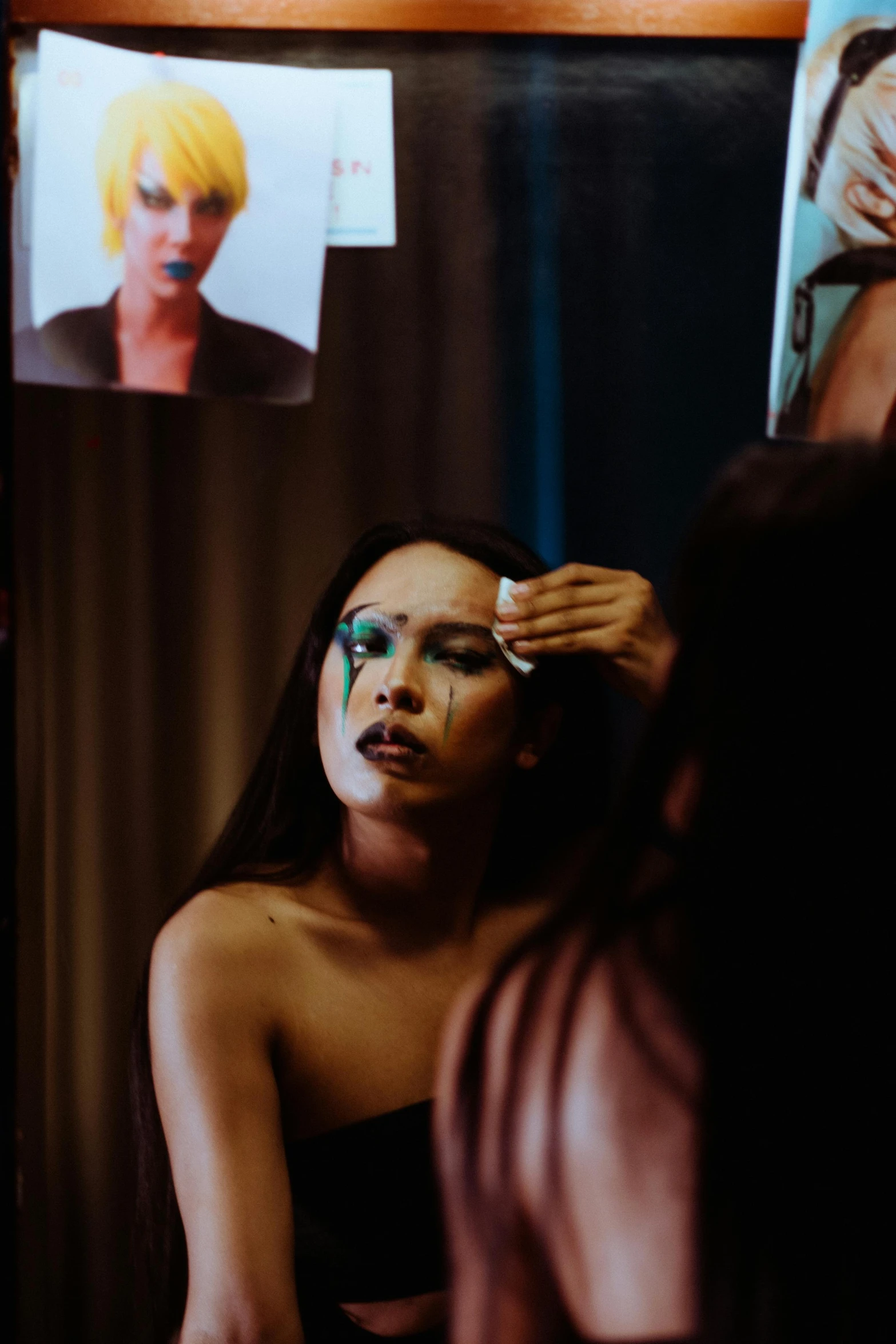 a woman getting her makeup done in front of a mirror, an album cover, inspired by Nan Goldin, trending on pexels, ru paul\'s drag race, portrait of vanessa morgan, set on singaporean aesthetic, emotional