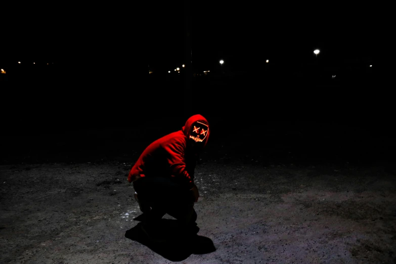 a man in a red hoodie crouches down in the dark, an album cover, pexels contest winner, goblinko, people at night, hyper realism scary, avatar image