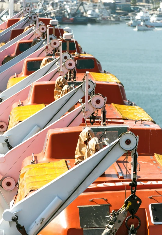 a row of boats sitting next to each other on a body of water, happening, pink and orange colors, utilitarian cargo ship, slide show, graphic print