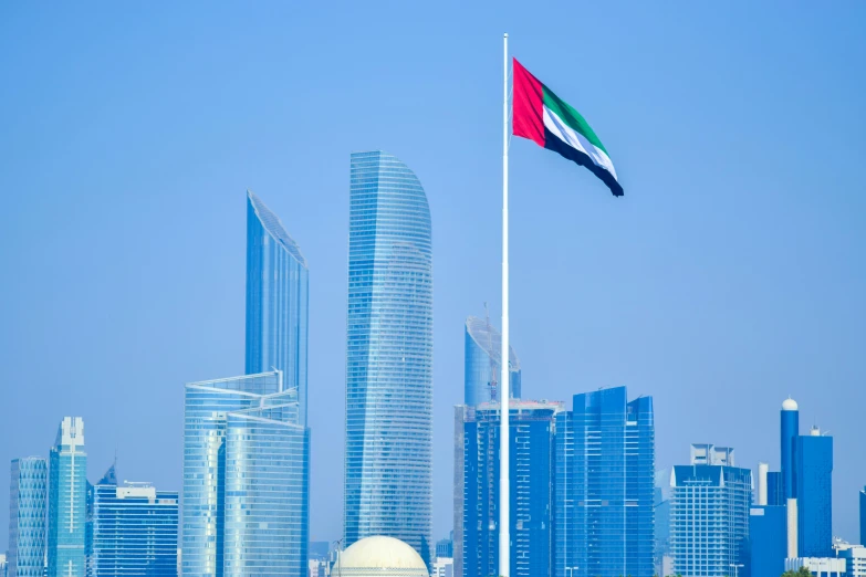 a flag flying in front of a city skyline, by Julia Pishtar, pexels contest winner, hurufiyya, square, gulf, norman foster, 15081959 21121991 01012000 4k