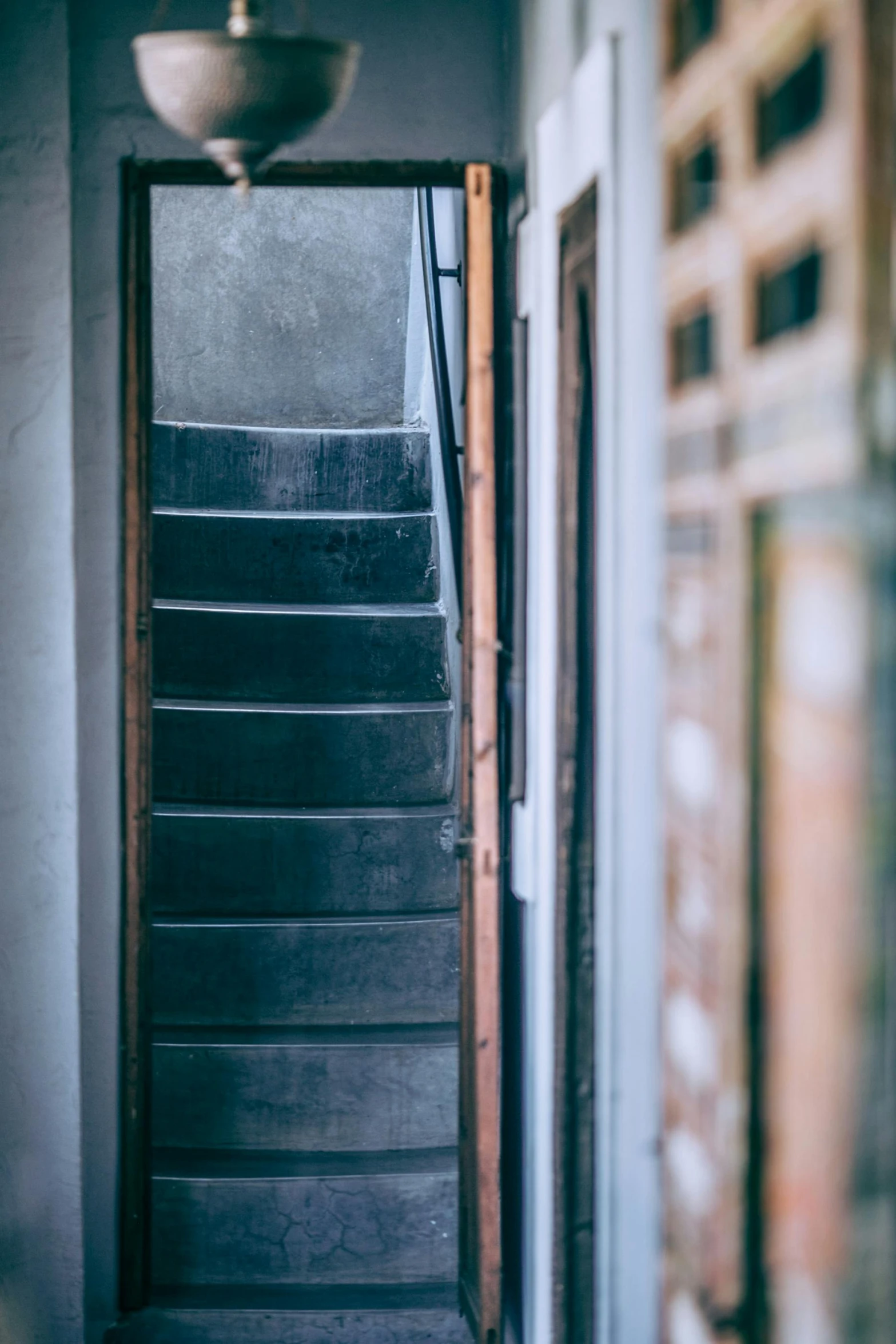 an open door leading to a set of stairs, inspired by Elsa Bleda, unsplash, renaissance, narrow footpath, grey, multicoloured, brown