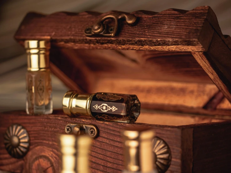 a bottle of perfume sitting inside of a wooden box, a macro photograph, trending on pexels, renaissance, inlaid with gold, small nixie tubes, thumbnail, brown