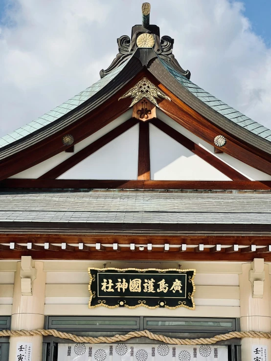 a close up of a building with a sky background, inspired by Itō Jakuchū, unsplash, sōsaku hanga, sign, square, an altar of a temple, photograph taken in 2 0 2 0