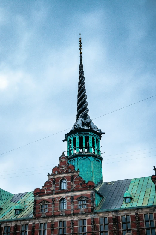 a large building with a clock tower on top of it, inspired by Hans Gude, copper and emerald, churches, devil's horns, photo taken in 2018