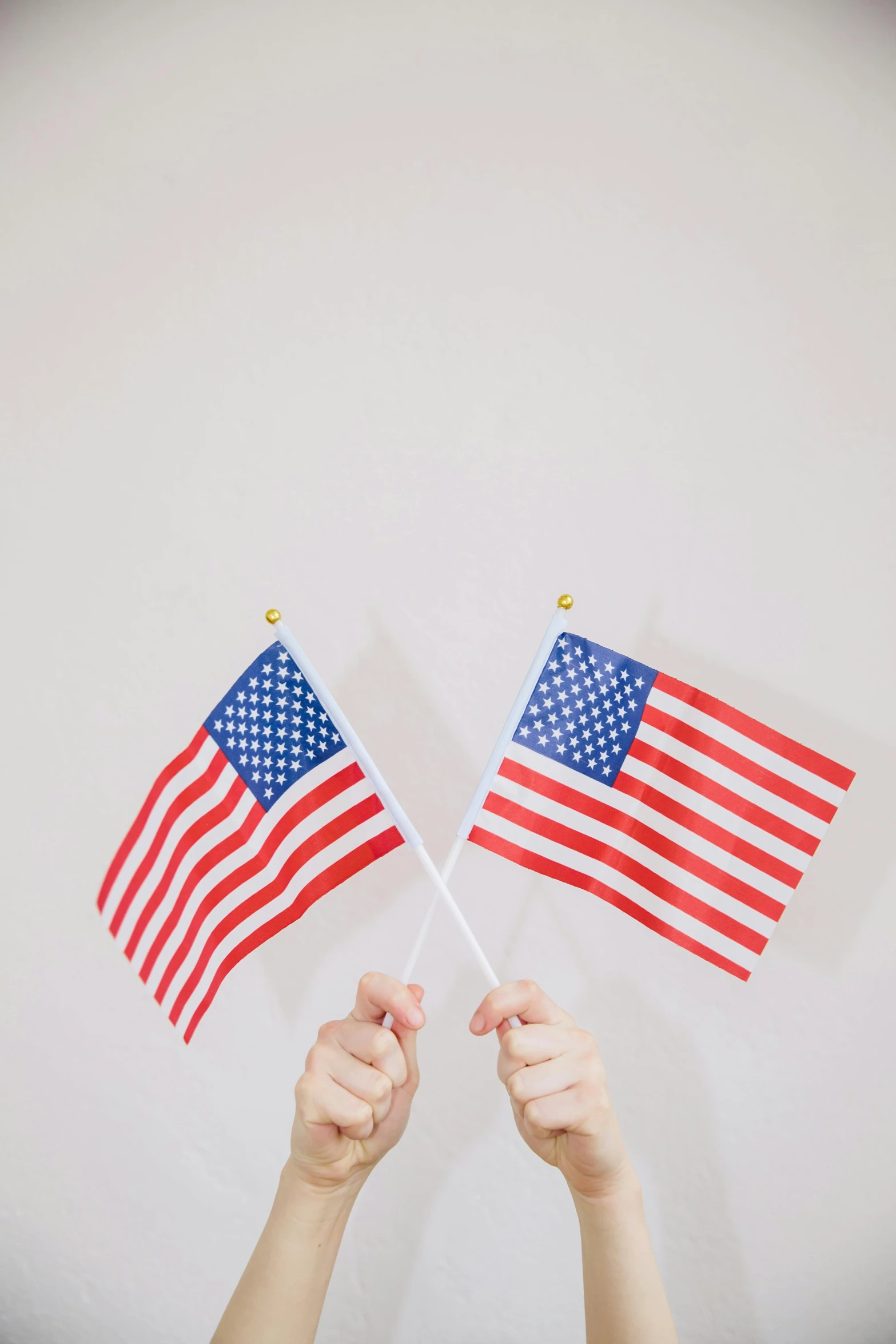 two hands holding american flags against a white background, by Gavin Hamilton, pexels, 🚿🗝📝, best practices, vertical orientation, julia sarda