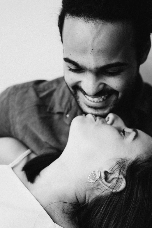 a black and white photo of a man and a woman, tumblr, happening, playful smile, riyahd cassiem, intimate holding close, centred