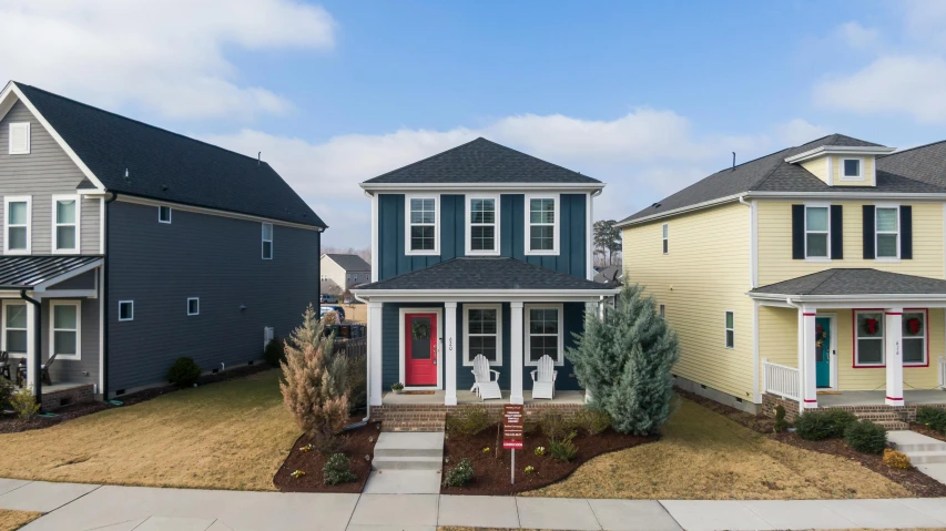 a couple of houses that are next to each other, a portrait, by Carey Morris, unsplash, square, blue and red two - tone, taken on go pro hero8, with a front porch