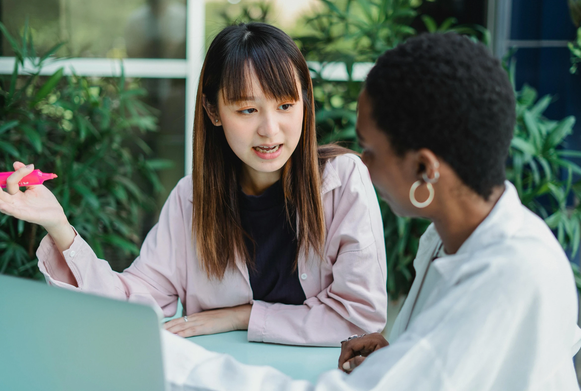 a couple of women sitting at a table with a laptop, trending on pexels, ethnicity : japanese, professional image, talking, nursing