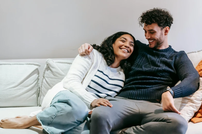 a man and a woman sitting on a couch, pexels contest winner, embracing, promotional image, lachlan bailey, smiling couple