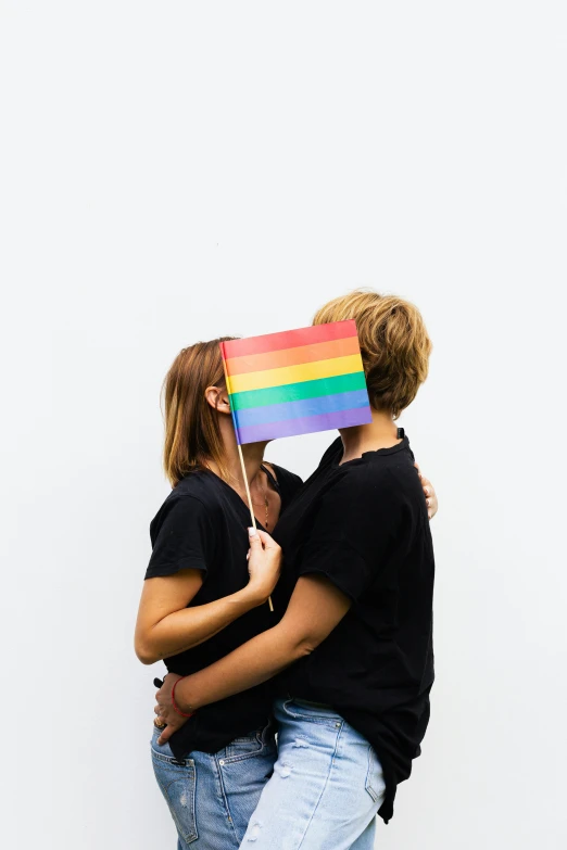 a man and a woman holding a rainbow flag, trending on unsplash, plain background, 🚿🗝📝