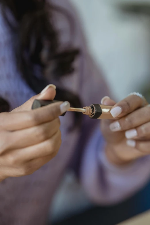 a close up of a person using a cell phone, incense, detailed product image, holding a wrench, collaboration