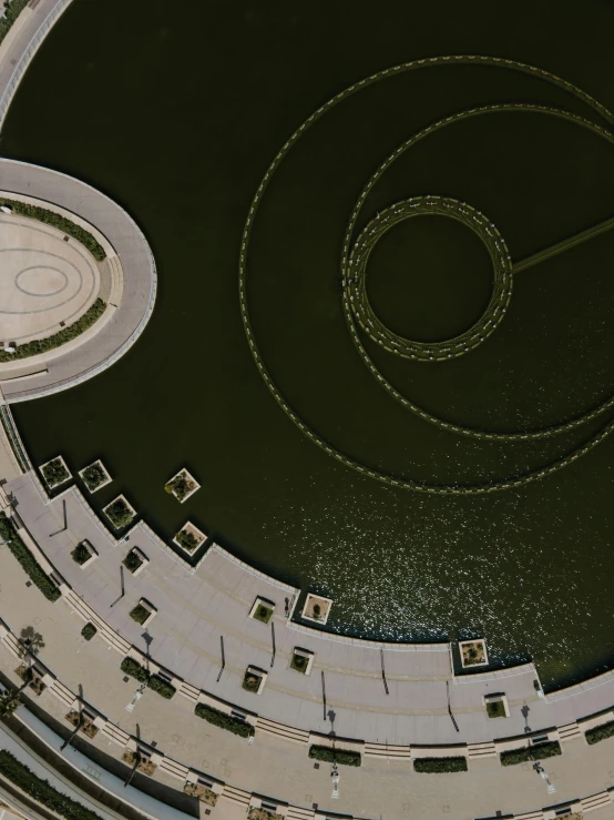 a bird's eye view of a circular building, pexels contest winner, land art, water jets, concrete poetry, super detailed image, cinematic composition 8 k