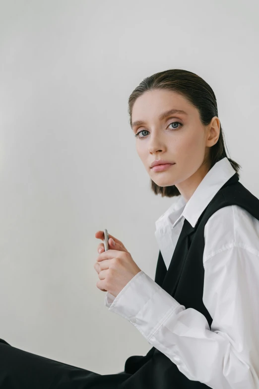 a woman in a white shirt and black vest, inspired by Josefina Tanganelli Plana, trending on pexels, elizabeth olsen, non binary model, professional modeling, architect