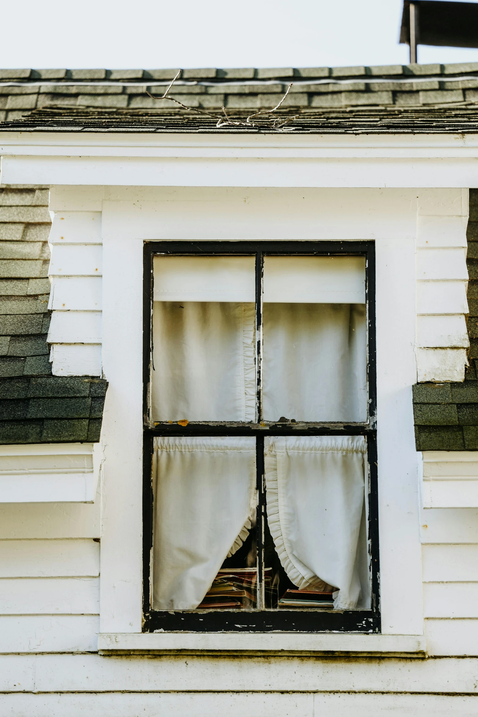 a close up of a window on a building, inspired by Andrew Wyeth, unsplash, amityville, curtains, under repairs, high resolution photo