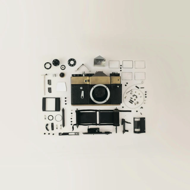 a camera sitting on top of a white table, a picture, by Andries Stock, unsplash contest winner, assemblage, knolling, intricate parts, flat color, dieter rams