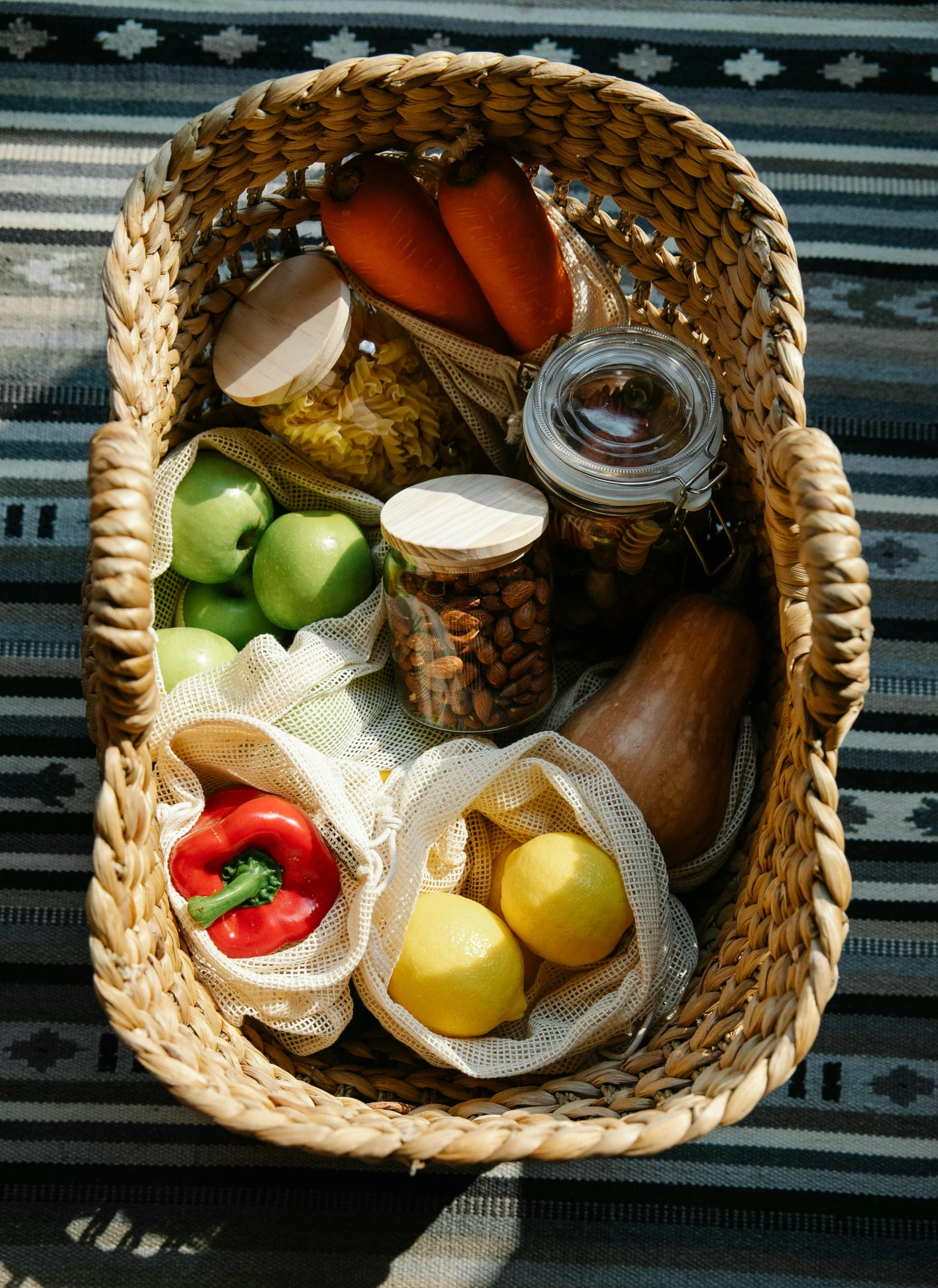 a basket full of food sitting on top of a table, in the sun, various items, top down shot, inside a glass jar