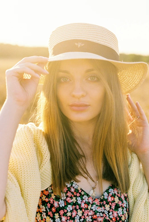 a woman standing in a field wearing a hat, inspired by Ksenia Milicevic, diffuse natural sun lights, headshot, rectangle, sunraise