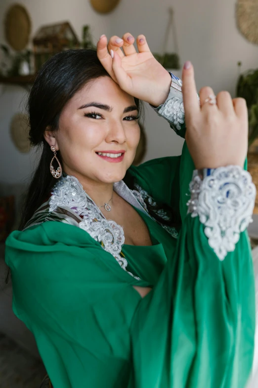 a woman in a green dress posing for a picture, hurufiyya, khyzyl saleem, profile image, digital image, close-up shoot