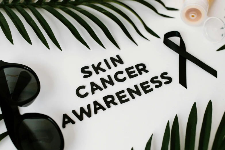 a pair of sunglasses and a sign that says skin cancer awareness, a photo, trending on pexels, avatar image, background image, wax skin, profile picture