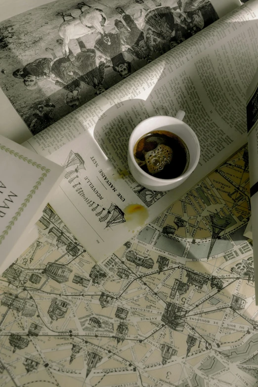 a sandwich sitting on top of a table next to a cup of coffee, a picture, by Simon Marmion, dada, map cartography, reading a newspaper, old photo scattered, ivory