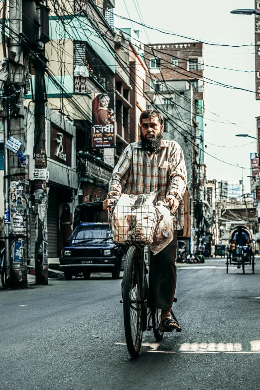 a man riding a bike down a city street, inspired by Steve McCurry, pexels contest winner, renaissance, bangkok, carrying survival gear, square, paisley