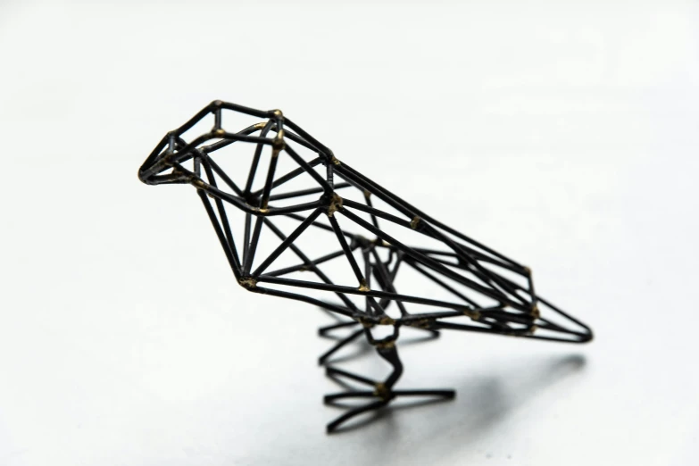 a wire sculpture of a bird on a white surface, unsplash, intricate triangular designs, black, miniature product photo, drawn with dots