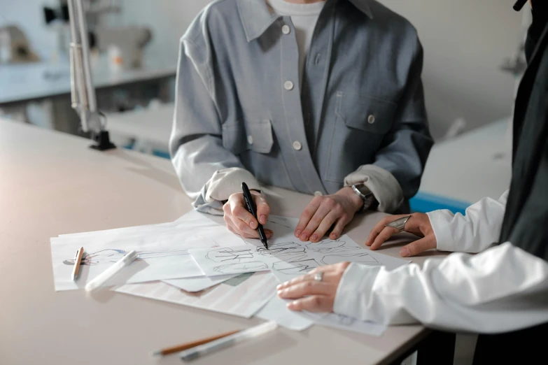 a couple of people that are sitting at a table, a drawing, trending on pexels, analytical art, academic clothing, surgical supplies, expert design, investigation