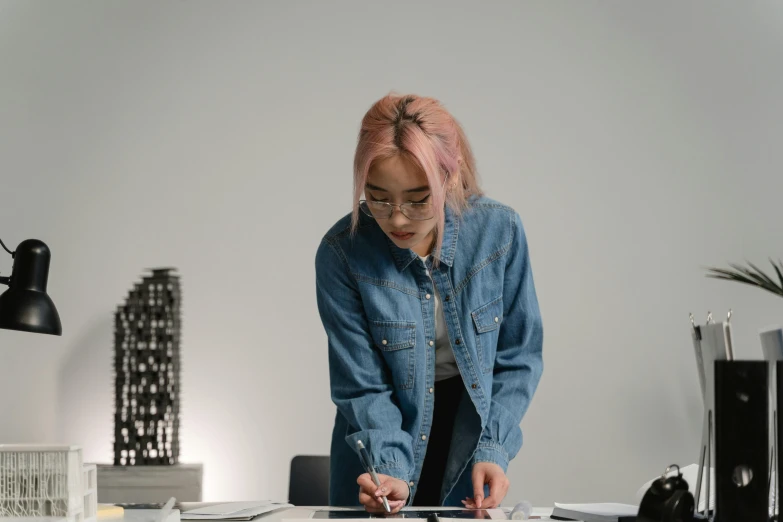 a woman that is standing in front of a desk, a drawing, trending on unsplash, visual art, wearing a jeans jackets, architect, performing, slight overcast lighting