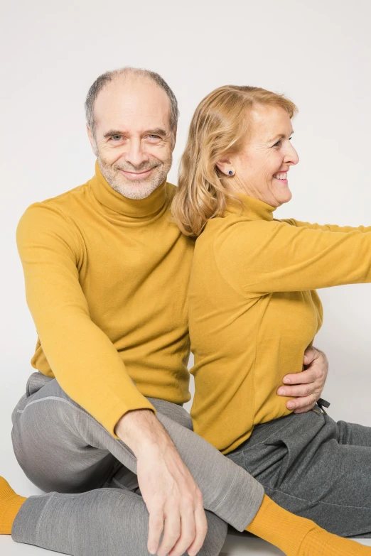 a man and a woman are sitting on the floor, antipodeans, his arms are behind his back, wearing a sweater, profile image, implants