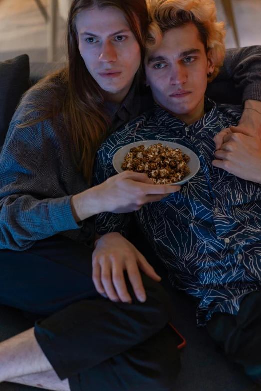 a man and a woman sitting on a couch holding a bowl of cereal, inspired by Nan Goldin, trending on pexels, hyperrealism, hugging, teenage boy, [ cinematic, holiday