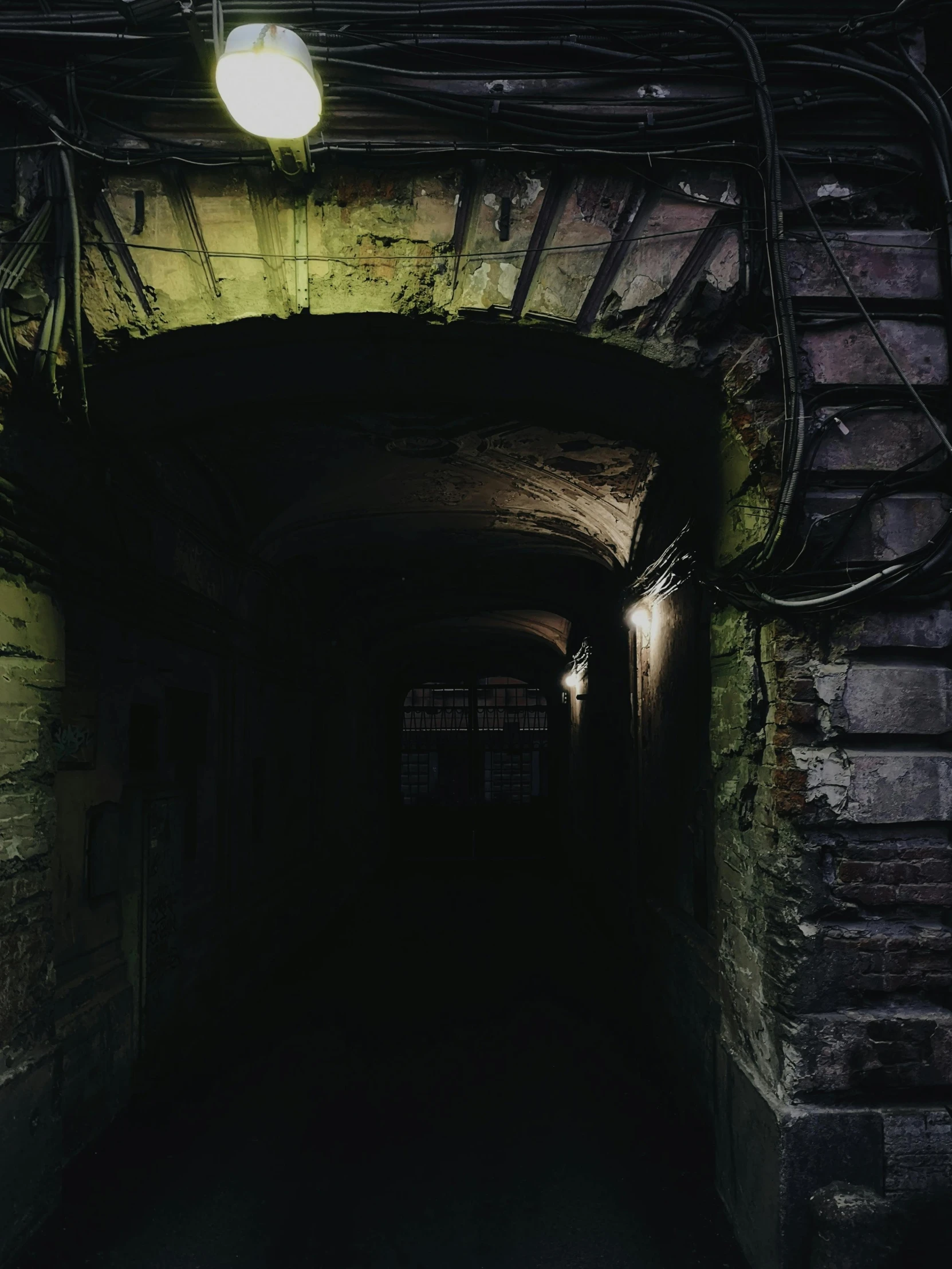 a dark tunnel with a light at the end, an album cover, pexels contest winner, entrance to 1900's mine, cyberpunk alley, promo image, indoor picture