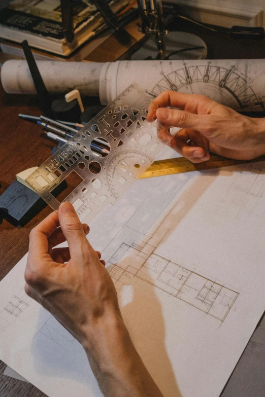 a person sitting at a table working on a piece of paper, a detailed drawing, pexels contest winner, arts and crafts movement, architectural plan, plating, handcrafted, white tracing