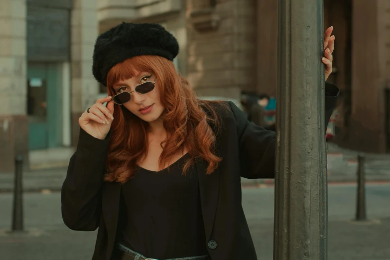 a woman standing on a street corner talking on a cell phone, an album cover, trending on pexels, renaissance, redhead girl, beret and sunglasses, total black outfit, cosplay photo