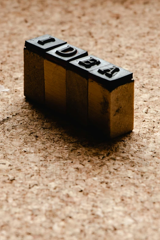 a close up of a block of wood on the ground, by Jesper Knudsen, private press, stamp, usa, language, thumbnail