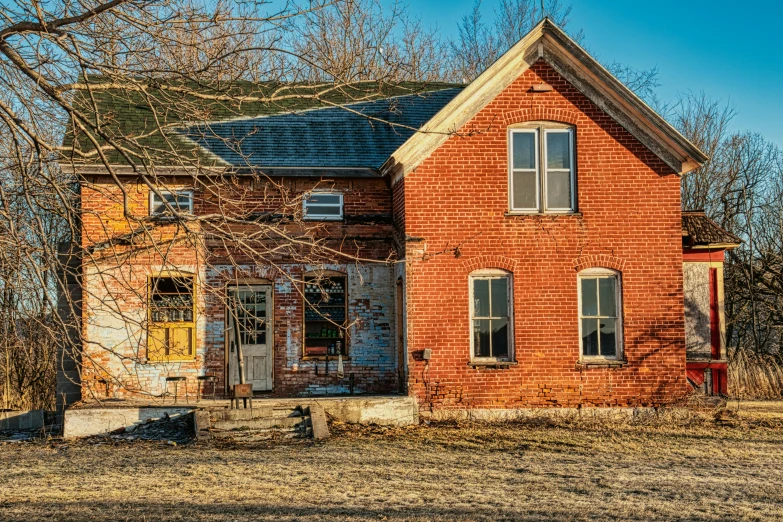 an old red brick house sitting in the middle of a field, pexels contest winner, folk art, new hampshire, old shops, demolition, golden hour photo