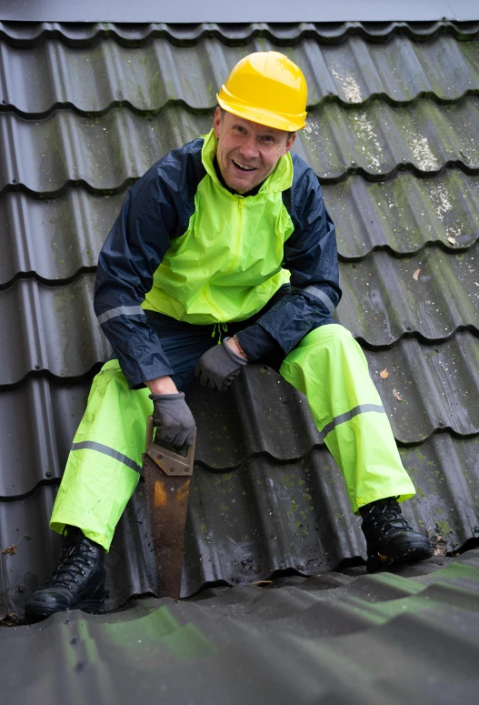 a man sitting on top of a metal roof, wearing hi vis clothing, thumbnail, as well as the handyboy, tiled