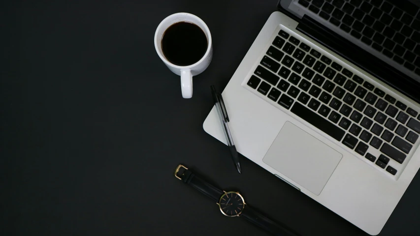 a laptop computer sitting on top of a desk next to a cup of coffee, a black and white photo, pexels, black jewellery, background image, black flat background, black and white clothes